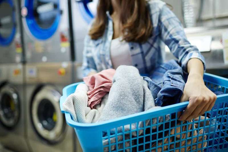 What is the difference between self-service and full-service laundromats?